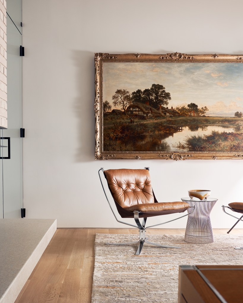 Dallas study with leather Falcon chair, landscape painting and custom furnishings.